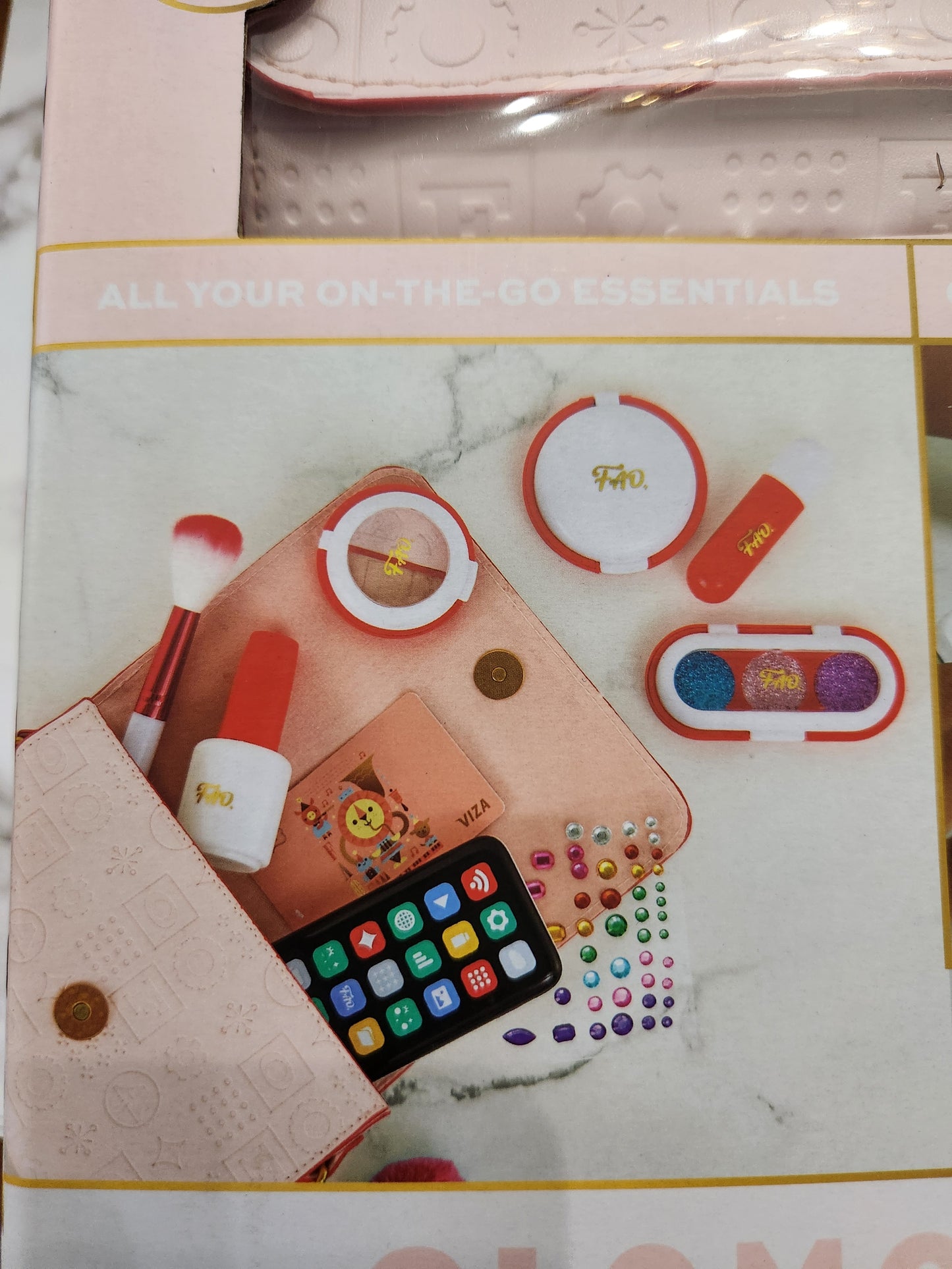 “Close-up of play lipstick, blush, and pretend credit card from FAO Schwarz set”
